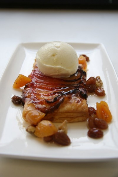Roast plum tart with vanilla ice-cream and vodka soused walnut and sultana syrup